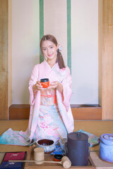 Young Asian Japanese woman in a Traditional Yukata Dress. Asian girl wearing a beautiful pink...
