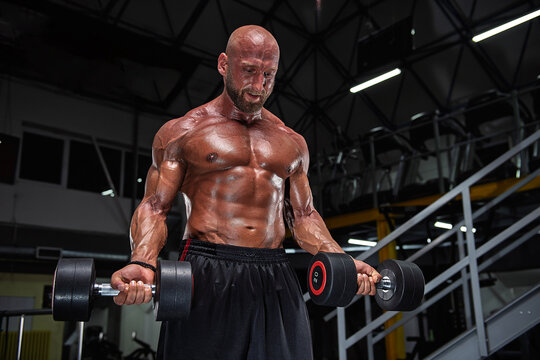 bodybuilder training with dumbbell
