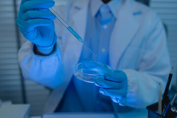 a female chemist is testing various liquid compounds in a lab, a scientist is doing research on the...