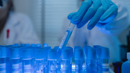a female chemist is testing various liquid compounds in a lab, a scientist is doing research on the...