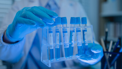 a female chemist is testing various liquid compounds in a lab, a scientist is doing research on the...