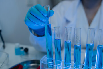 when in a lab, scientists wear lab coats, rubber gloves, and safety goggles, two chemists are...