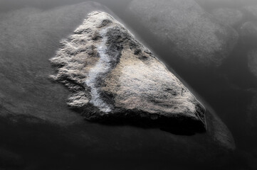 Natural coastal rock formation in Sweden surrounded by calm waters at dawn