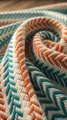 Close up of textured knit fabric with teal and orange chevron pattern