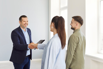 Realtor deal, real happy estate agent hand shake offering young couple family property, buying and selling, helping consultation about mortgage, insurance, rent, tenancy agreement, building contract