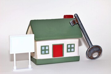 Miniature houses with key, symbolizing real estate investment and financial growth, copy space for...