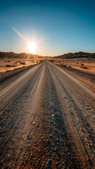 Desert Road at Sunset: A sun-kissed dirt road stretches into the horizon, framed by dunes under a clear blue sky.