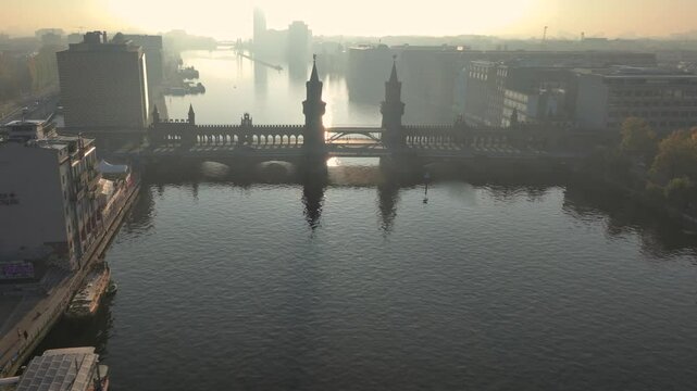 The Oberbaum Bridge, Oberbaumbrucke in Kreuzberg, a double-deck bridge crossing River Spree in Berlin, Germany. Aerial at Sunrise Morning Time.