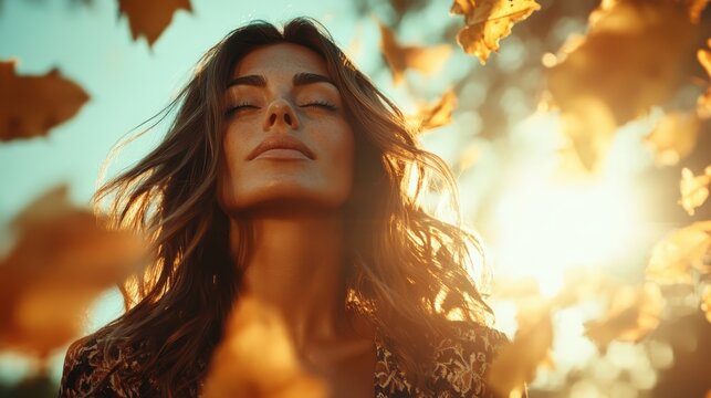 A woman gazes peacefully into the distance amidst golden autumn leaves, embodying tranquility and connection to nature, lit by the warm glow of the setting sun. - Powered by Adobe