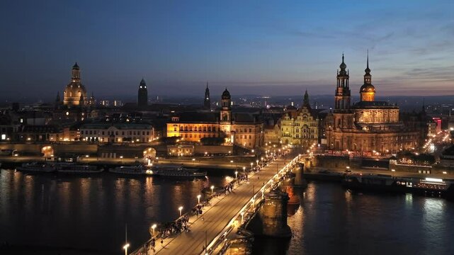 Dresden's historic Old Town at night, with Elbe River reflecting city lights. Dresren, Saxony, Germany. Aerial View.