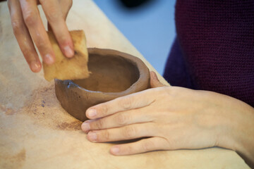 Shape clay with hands