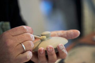 Shape clay with hands