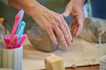 Shape clay with hands