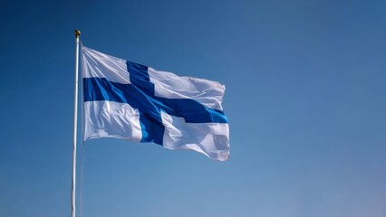 Finland flag waving under clear blue sky, symbolizing national pride and identity