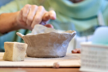 Shape clay with hands
