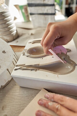 Shape clay with hands