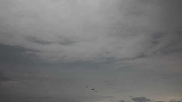 Formation flight of vintage military aircraft led by Boeing B17 Flying Fortress under dramatic cloudy sky evokes World War II nostalgia air power heritage and cinematic historical tension