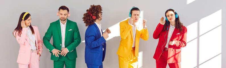 Group of stylish people dance, immersing themselves in their own musical worlds through headphones....