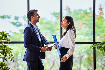 Chasing project deadline indoors, Indian corporate team discusses work using tablet in office