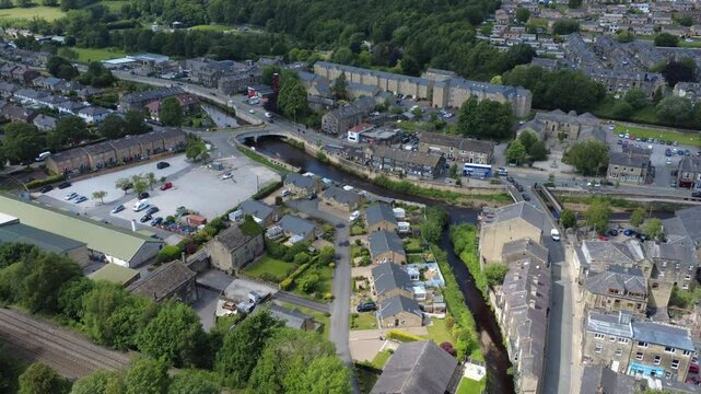 aerial drone view of the village of Mytholmroyd in Calderdale West Yorkshire showing the main road and river surrounded by houses