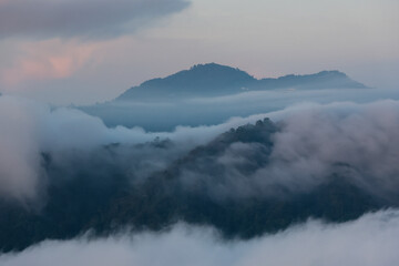 High-angle view of fog on the mountain. fog on the mountain. The forest is lush and green in the northern part of Thailand. The background is refreshing. It gives a feeling of being filled with life.