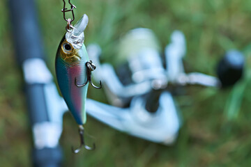 Close-up of a fishing lure on a spinning rod background. Sport fishing. Fishing tackle