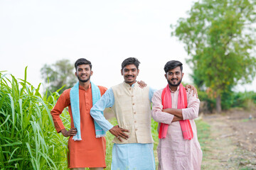 young indian farmer group standing together at agricultural field