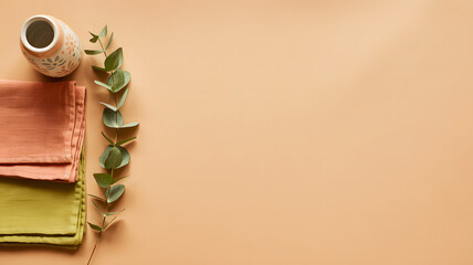 Minimalist Autumn Table Setting with Ceramic Vase and Eucalyptus on Peach Background