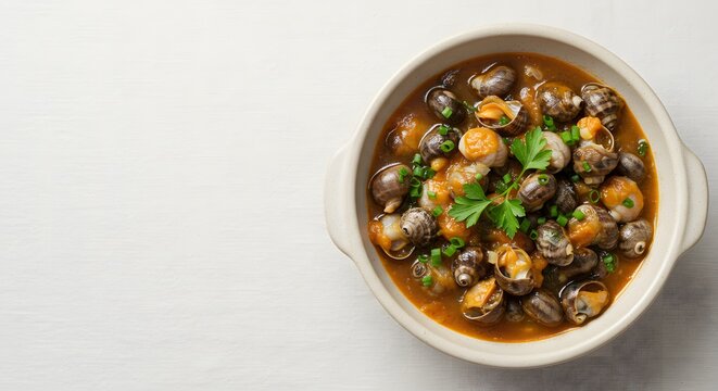 Top view of Buzio (whelk stew), ceramic bowl placed at right third, minimalist top view with fresh herbs for garnish (top view) 2.