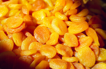 Fresh dried apricots in rays of light close-up. Organic dietary product.