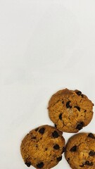 Three chocolate chip cookies isolated on white background. Background template.