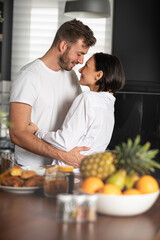 Couple hugging in kitchen
