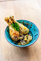 Two chicken wings served in blue oriental bowl, fusion food with ethnic ceramic design