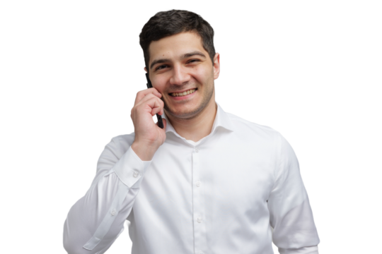 Smiling man in white shirt engaged in a joyful phone conversation 