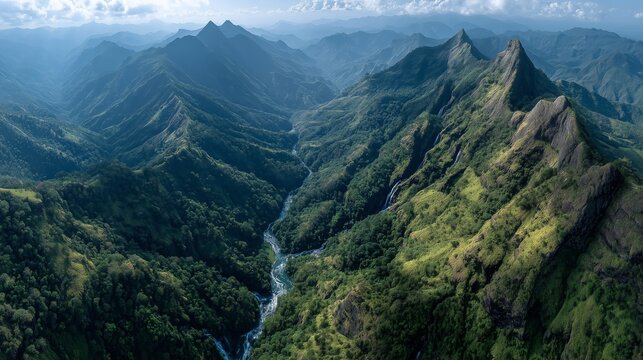 Drone photo capturing a panoramic view of a pristine green valley with a winding river, waterfall, and dense forest under a mountainous horizon—ideal for ecotourism, adventure travel, and nature conse