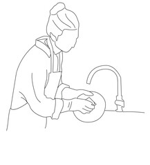 woman washing dishes. woman wearing apron holding scourer washing dishes.