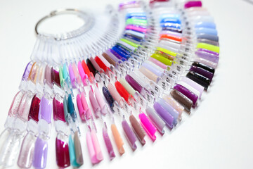 Nail polish. A palette of colorful nail polishes on a white background
