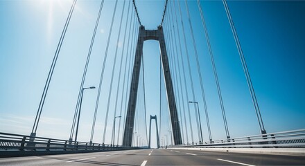 Obraz premium Low-Angle Shot of Modern Suspension Bridge Against Blue Sky