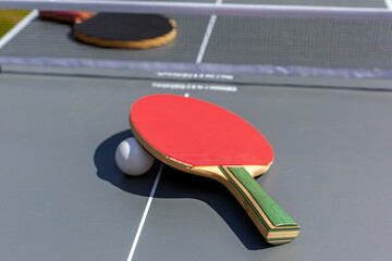 Composition on the grey tennis table, High angle view of red racket on table