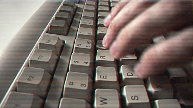 Computer engineer developer is working on old vintage computer 1990s. Antique classic pc keyboard and programmer typing hands. Internet web digital startup history. Outdated retro technology concept