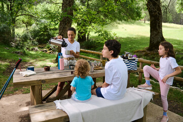 Family Enjoying a Relaxing Picnic in a Scenic Park Setting on a Summer Day