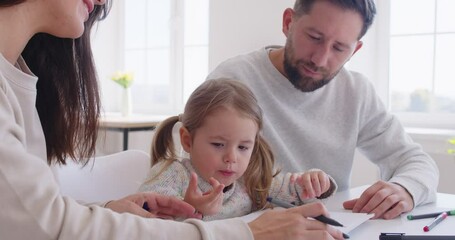 Family and little daughter enjoy painting and drawing together at home, sitting at desk. Creative leisure activity combines art, education, and bonding, fostering a strong family connection.