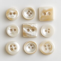 Assortment of Mother of Pearl Buttons, Various Shapes and Sizes on White Background