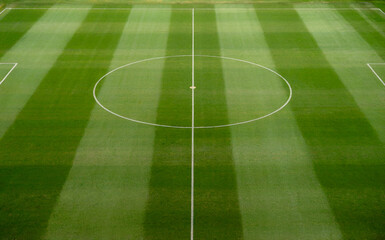Obraz premium Empty Soccer Field with Pristine Striped Grass and Symmetrical Markings