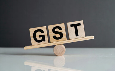 Minimalist GST Balance Concept with Wooden Blocks on Seesaw Fulcrum