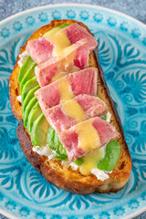 Tuna avocado sandwich with labneh and mustard-lemon sauce on toasted bread