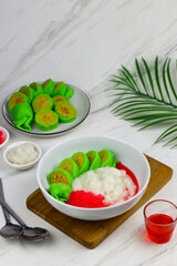 Es Pisang Ijo or Green banana ice, one of Indonesian popular dessert from east Sulawesi, Makassar. Es Pisang ijo made from banana coated with green flour dough, serve with red syrup.