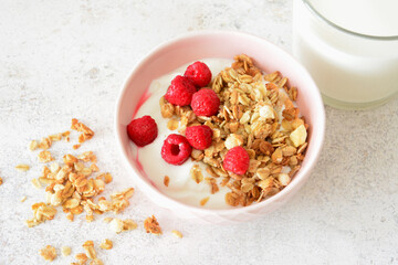 breakfast bowl with yogurt, granola and fresh raspberries flat lay healthy menu