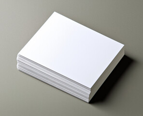 Stack of blank business name cards isolated on a gray background.