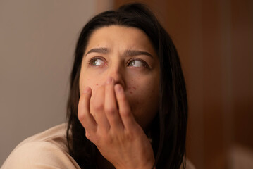 A young woman in the morning sun with blemishes. Illustrative photo for a cosmetic skin product.